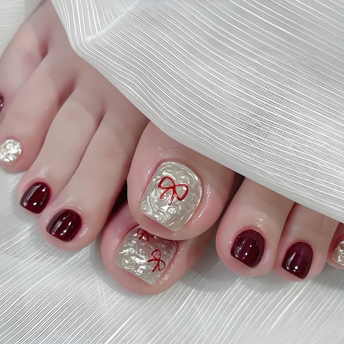 mẫu nail chân màu đỏ vẽ nơ đẹp